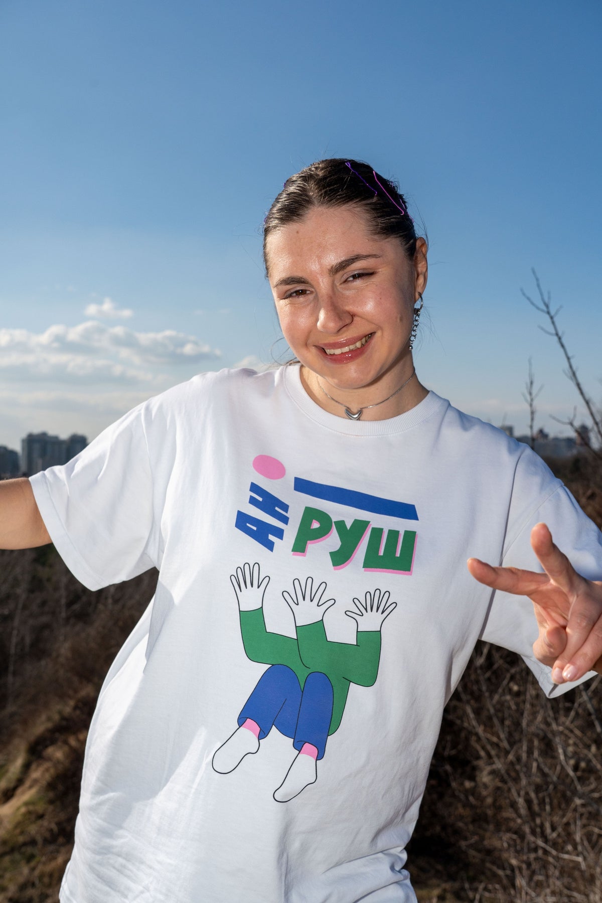Model wearing the white Ani Rush T-shirt with its illustrated print