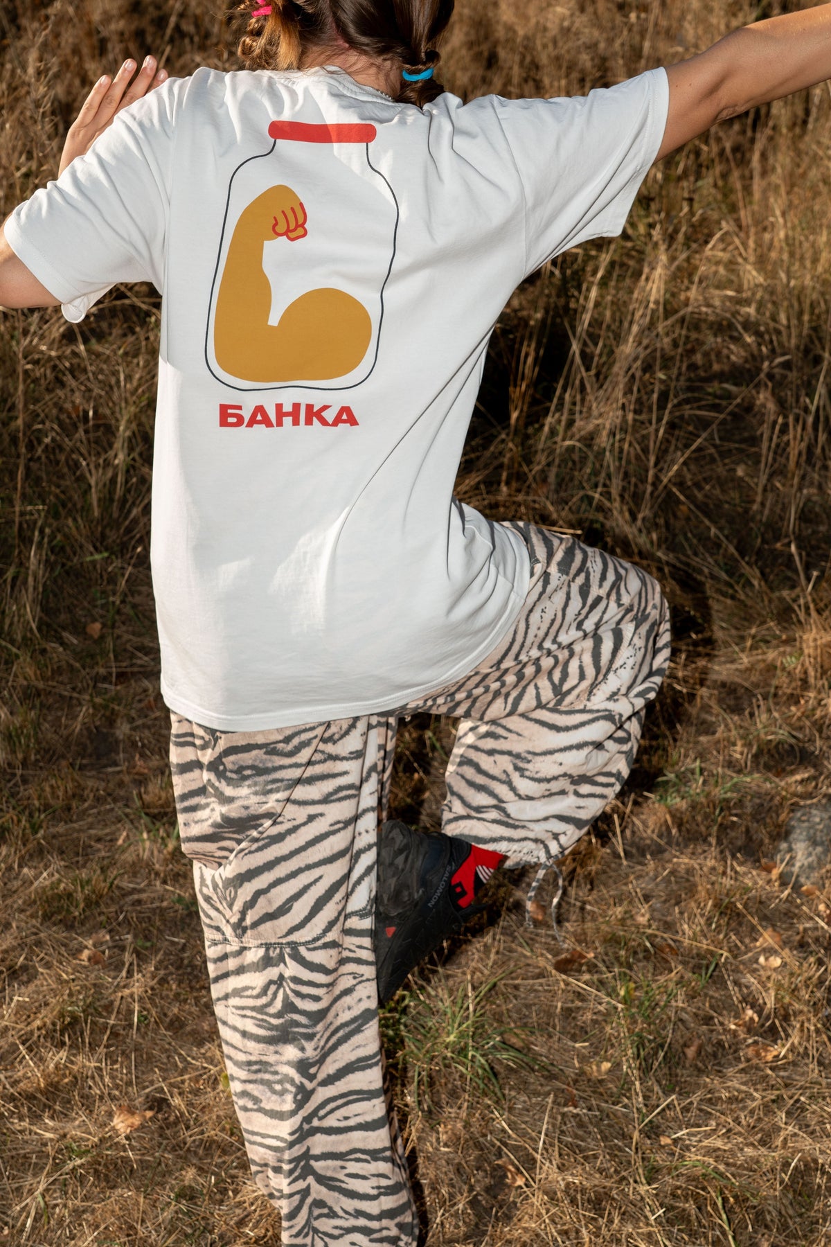 Woman wearing the Banka T-shirt, showing its jar print on the back